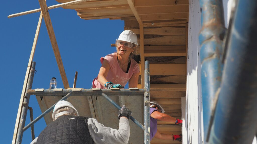A woman in construction on scaffolding