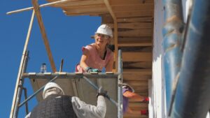 A woman in construction on scaffolding